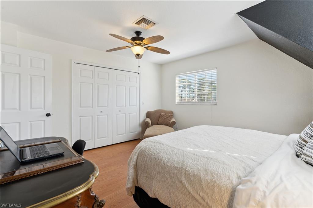 8457 Wren Road Fort Myers, FL 33967 - Photo 30 of 50 Bedroom with ceiling fan, a closet, and light hardwood / wood-style floors