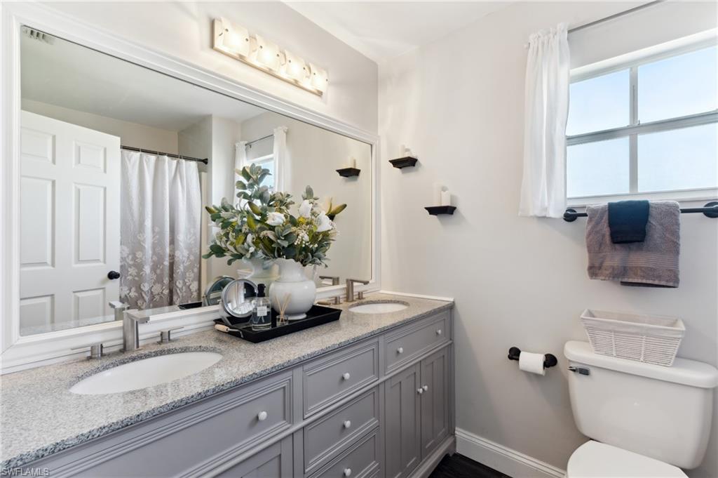 8457 Wren Road Fort Myers, FL 33967 - Photo 31 of 50 Bathroom with vanity, toilet, and plenty of natural light