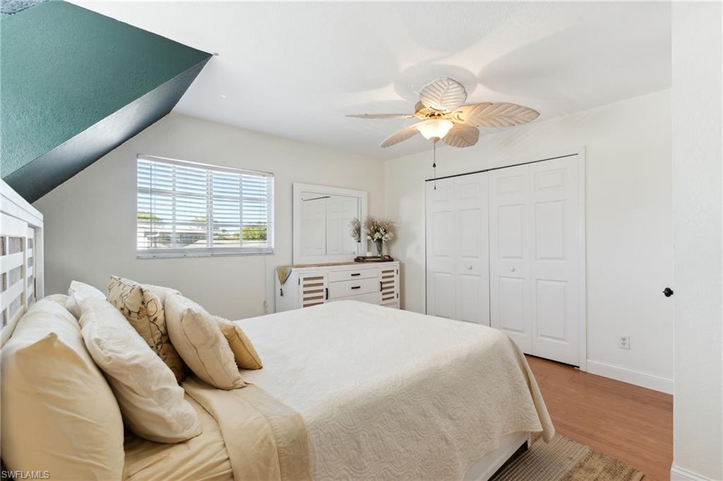 8457 Wren Road Fort Myers, FL 33967 - Photo 34 of 50 Bedroom featuring ceiling fan, vaulted ceiling, and light hardwood / wood-style flooring