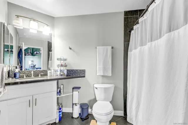 a bathroom with a toilet a sink and a mirror