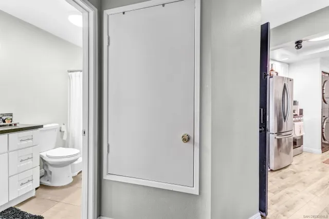 a bathroom with a toilet sink and a mirror