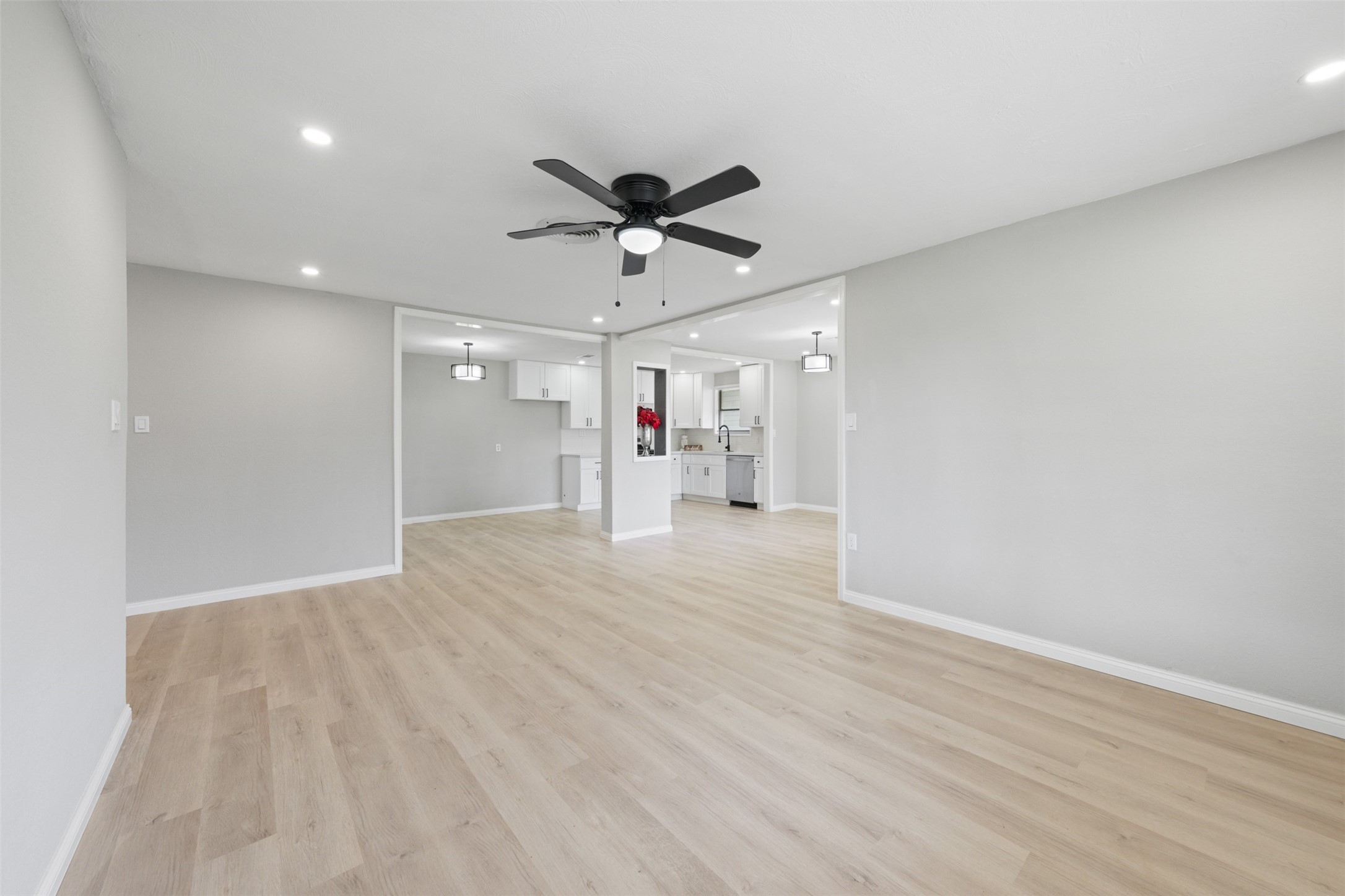 4356 Phlox Street Houston, TX 77051 - Photo 14 of 25 a view of a livingroom with a ceiling fan wooden floor and a ceiling fan