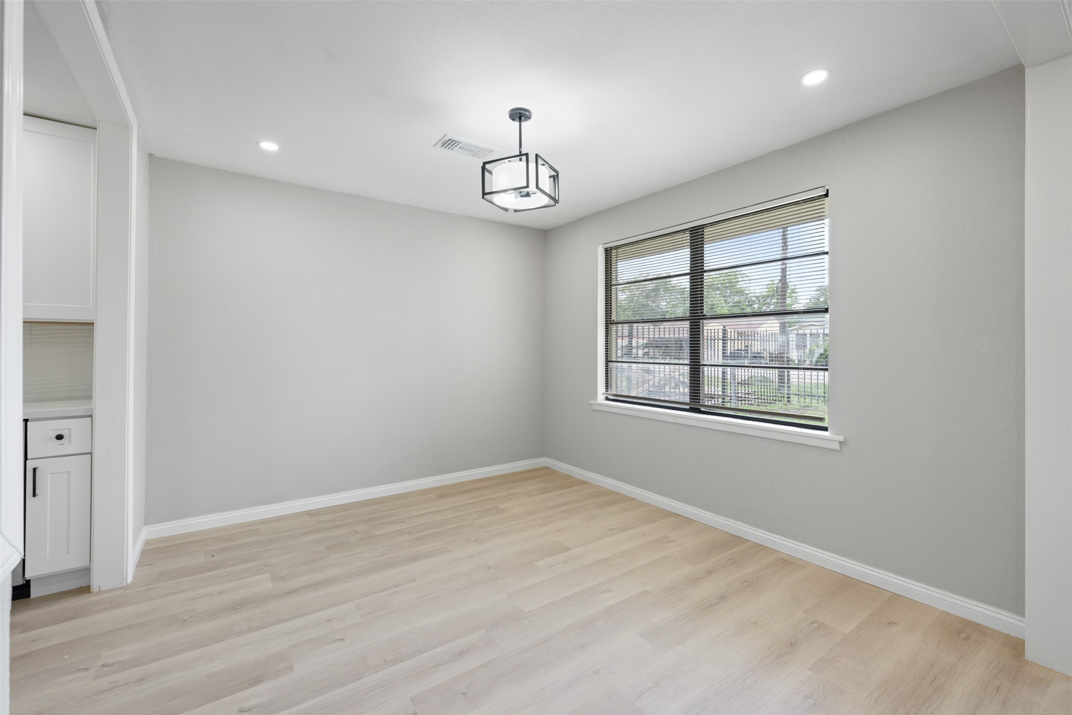 4356 Phlox Street Houston, TX 77051 - Photo 15 of 25 an empty room with wooden floor fan and windows