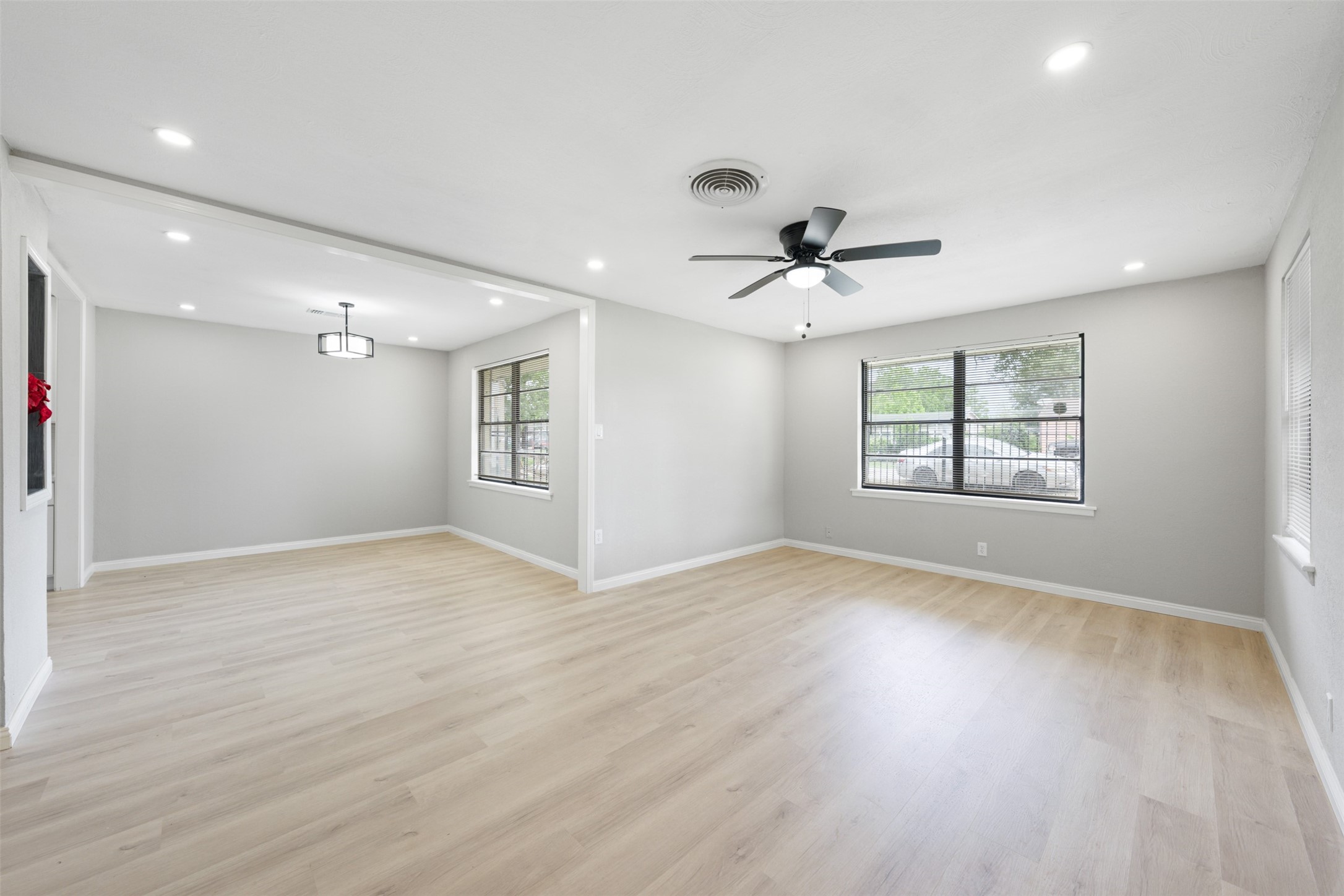 4356 Phlox Street Houston, TX 77051 - Photo 6 of 25 a view of an empty room with a window and wooden floor