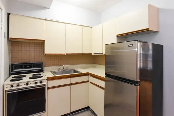 a kitchen with stainless steel appliances a refrigerator sink and stove