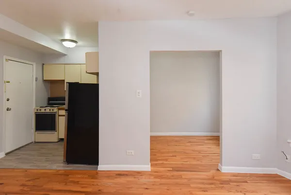 a view of a kitchen with wooden floor