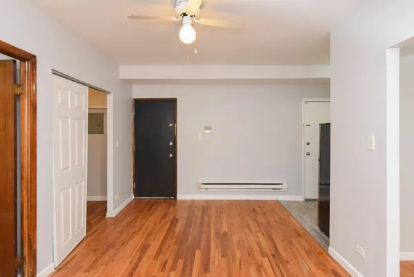 a view of empty room with wooden floor