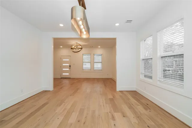 a view of a livingroom with wooden floor and window