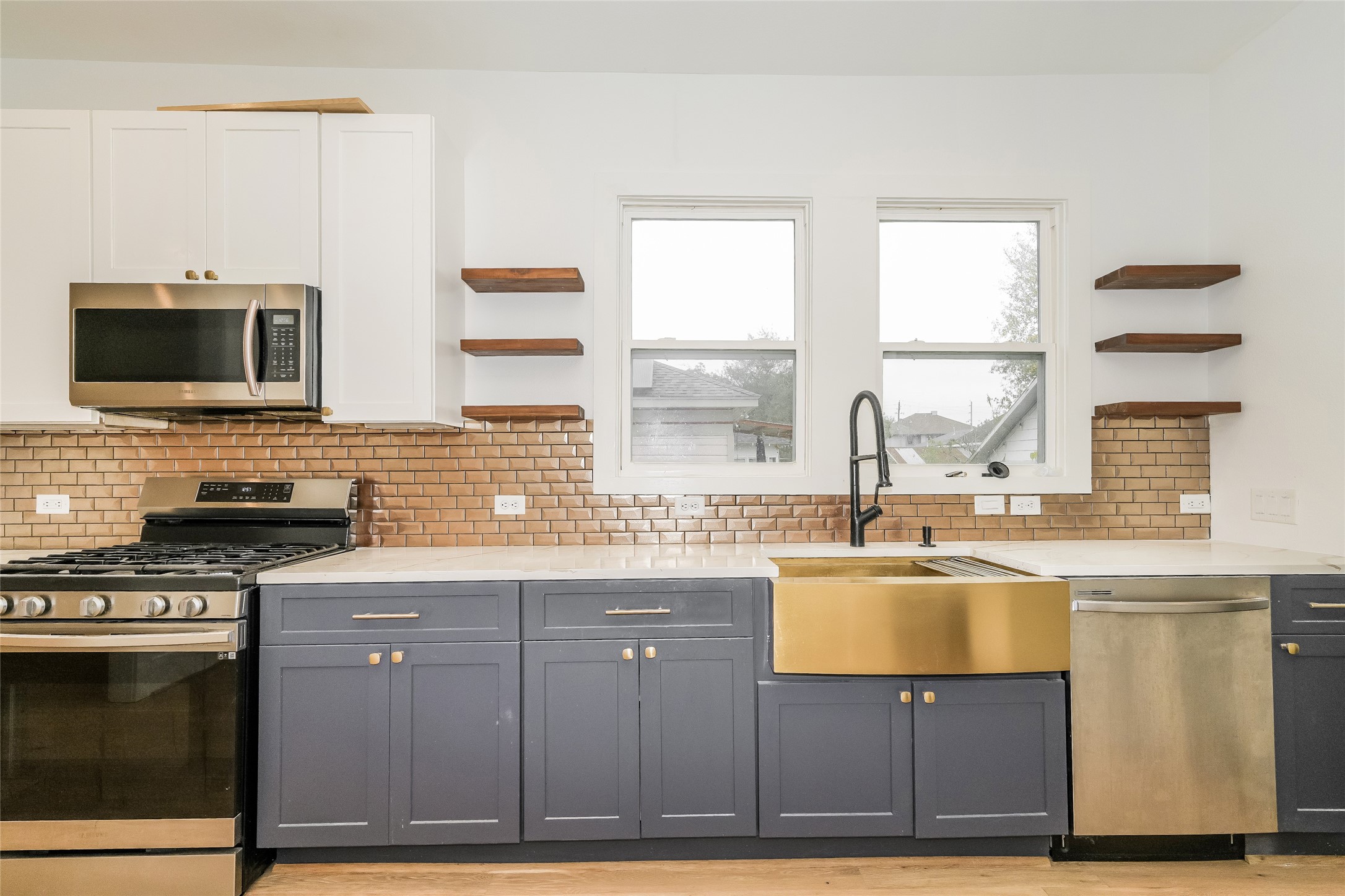 231 Grace Street Houston, TX 77003 - Photo 7 of 15 a kitchen with stainless steel appliances granite countertop a stove a sink and a microwave