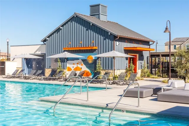 a view of a house with swimming pool and sitting area