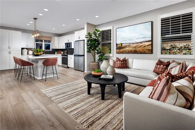 a living room with furniture kitchen and a table