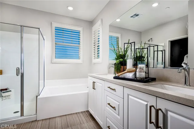 a bathroom with a tub sink and mirror