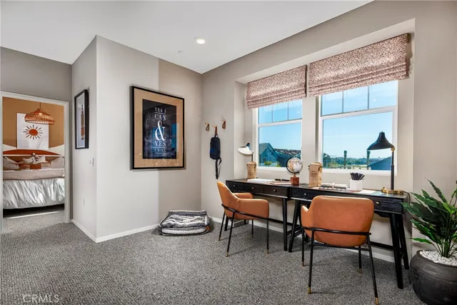 a dining room with furniture and a large window