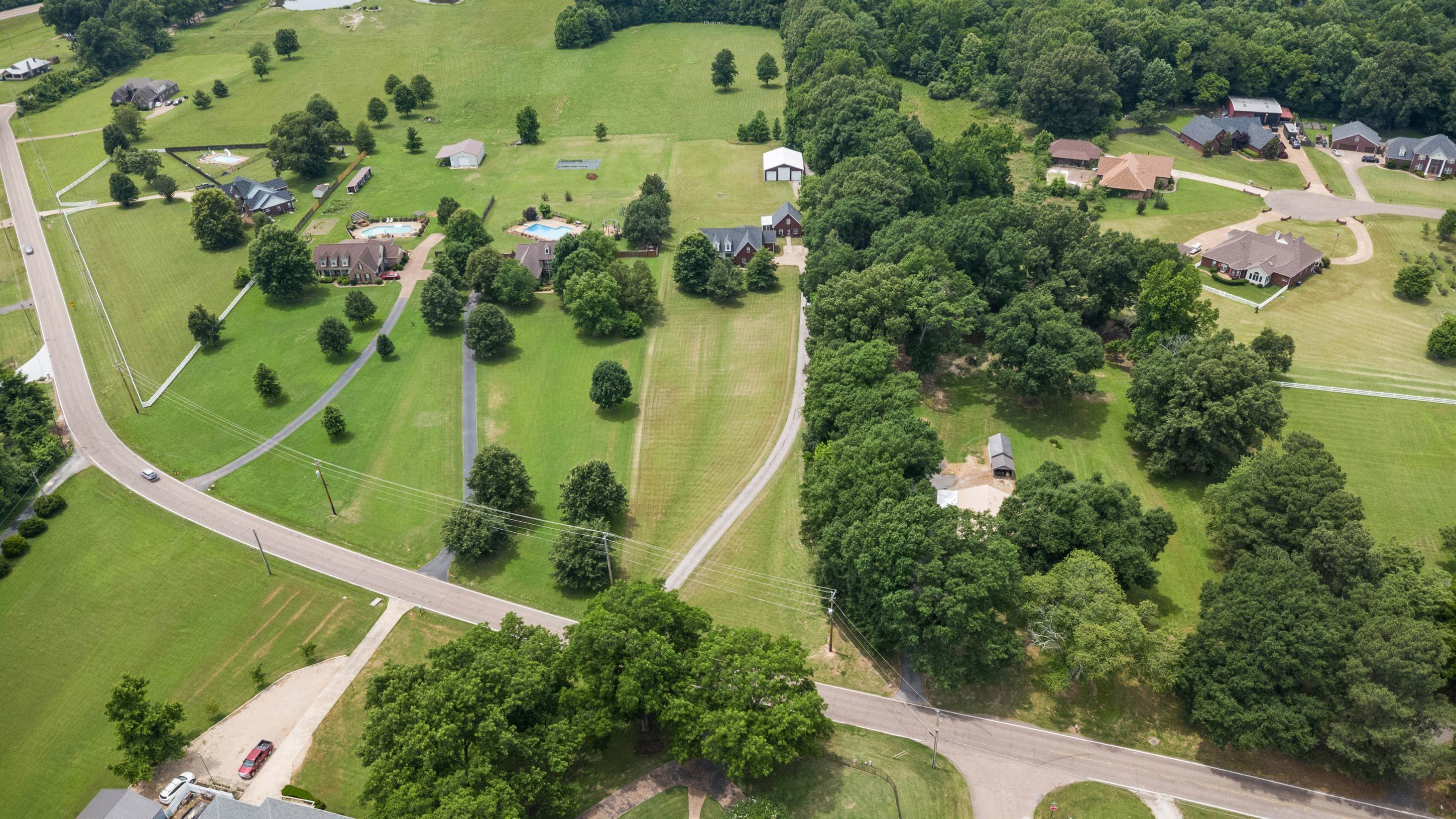 7757 Brunswick Road Millington, TN 38053 - Photo 39 of 40 Expansive green landscape with scattered mature trees and paved roadways