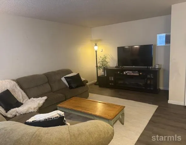 a white kitchen with stainless steel appliances a stove a sink and a microwave