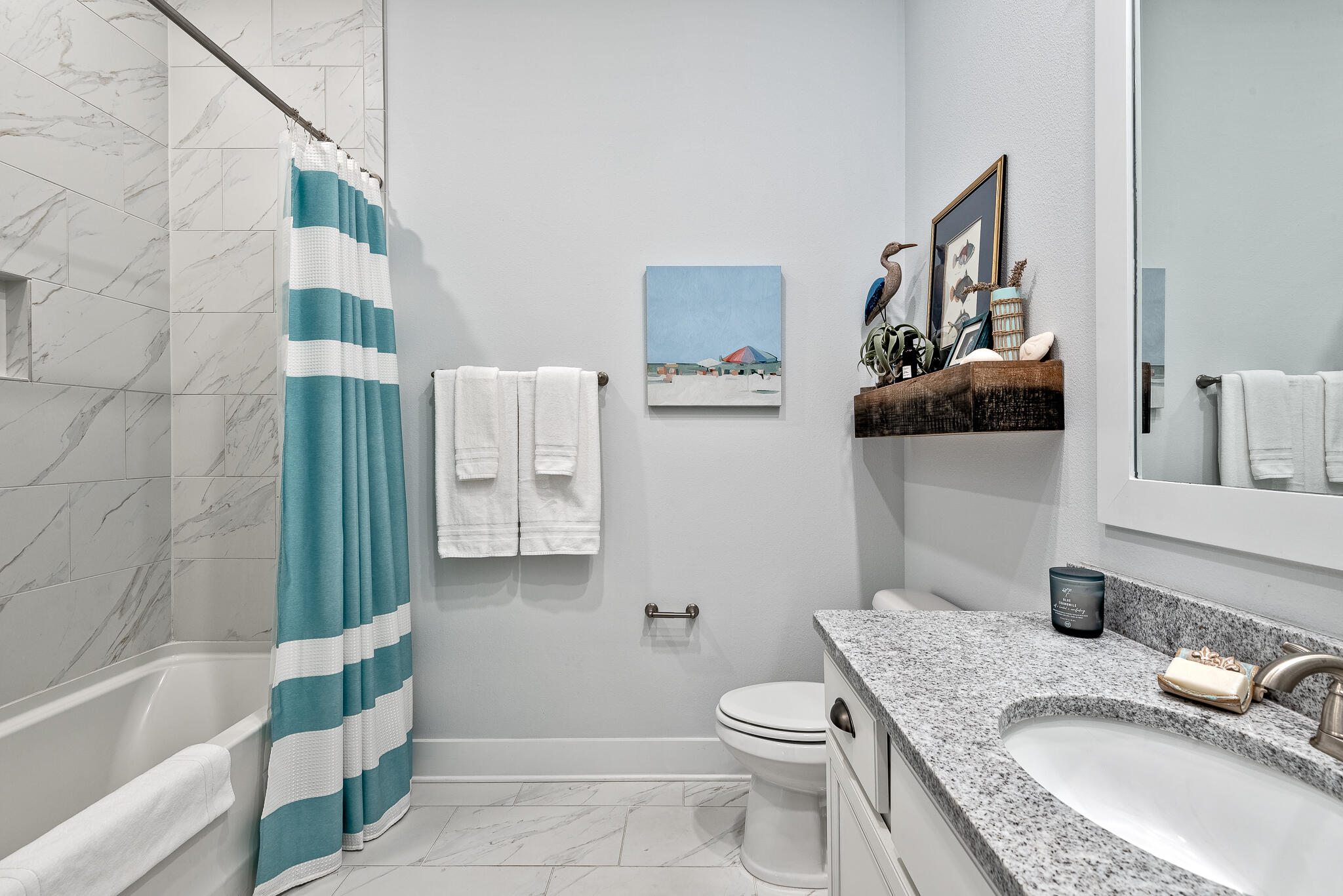 Undisclosed Address Inlet Beach, FL 32461 - Photo 16 of 25 a bathroom with a granite countertop toilet sink and mirror