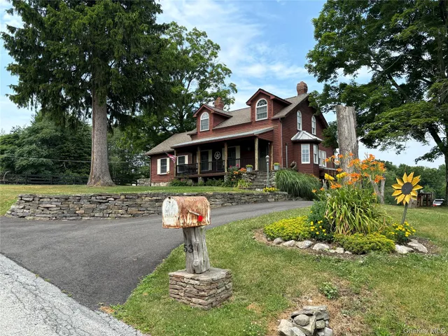 a front view of a house with a yard garage and outdoor seating