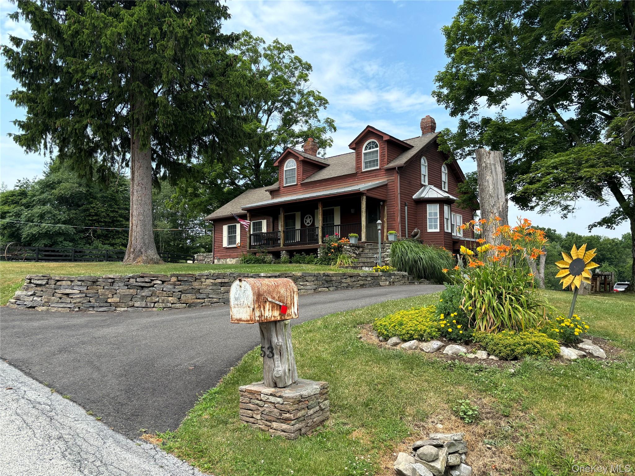 a front view of a house with a yard garage and outdoor seating