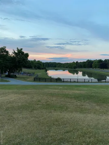 a view of outdoor space with green field and trees