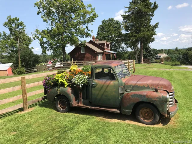 a view of a backyard with table and chairs and a fire pit