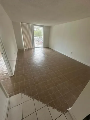 a view of an empty room and a window