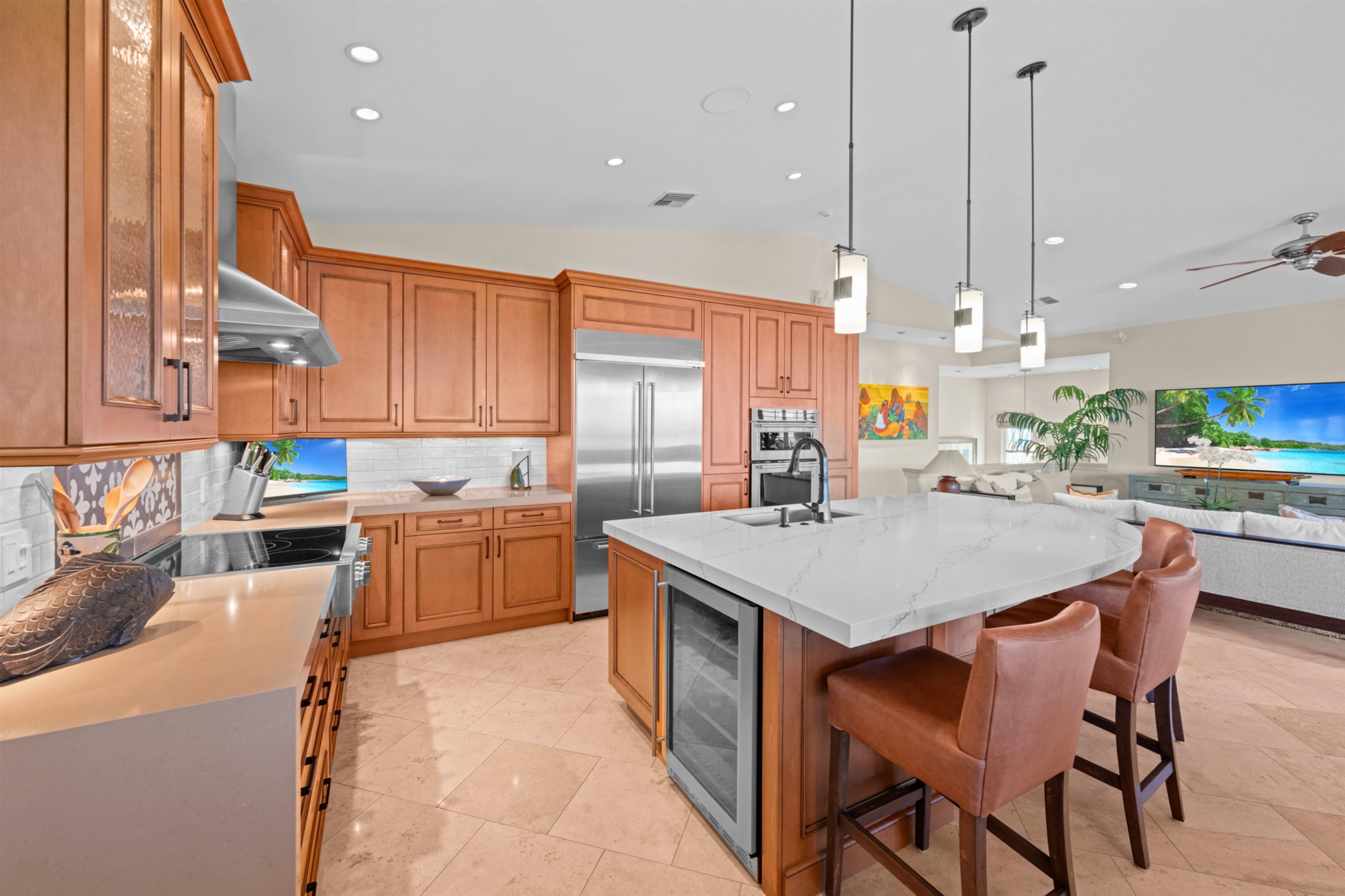 17 Kahana Ridge Place Lahaina, HI 96761 - Photo 6 of 50 a kitchen with stainless steel appliances kitchen island granite countertop a table chairs sink and cabinets