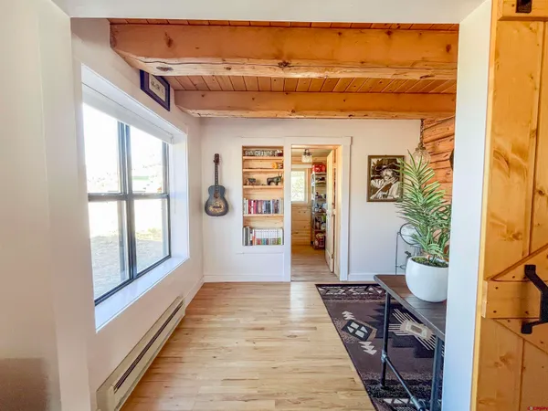 a view of entryway and hall with wooden floor