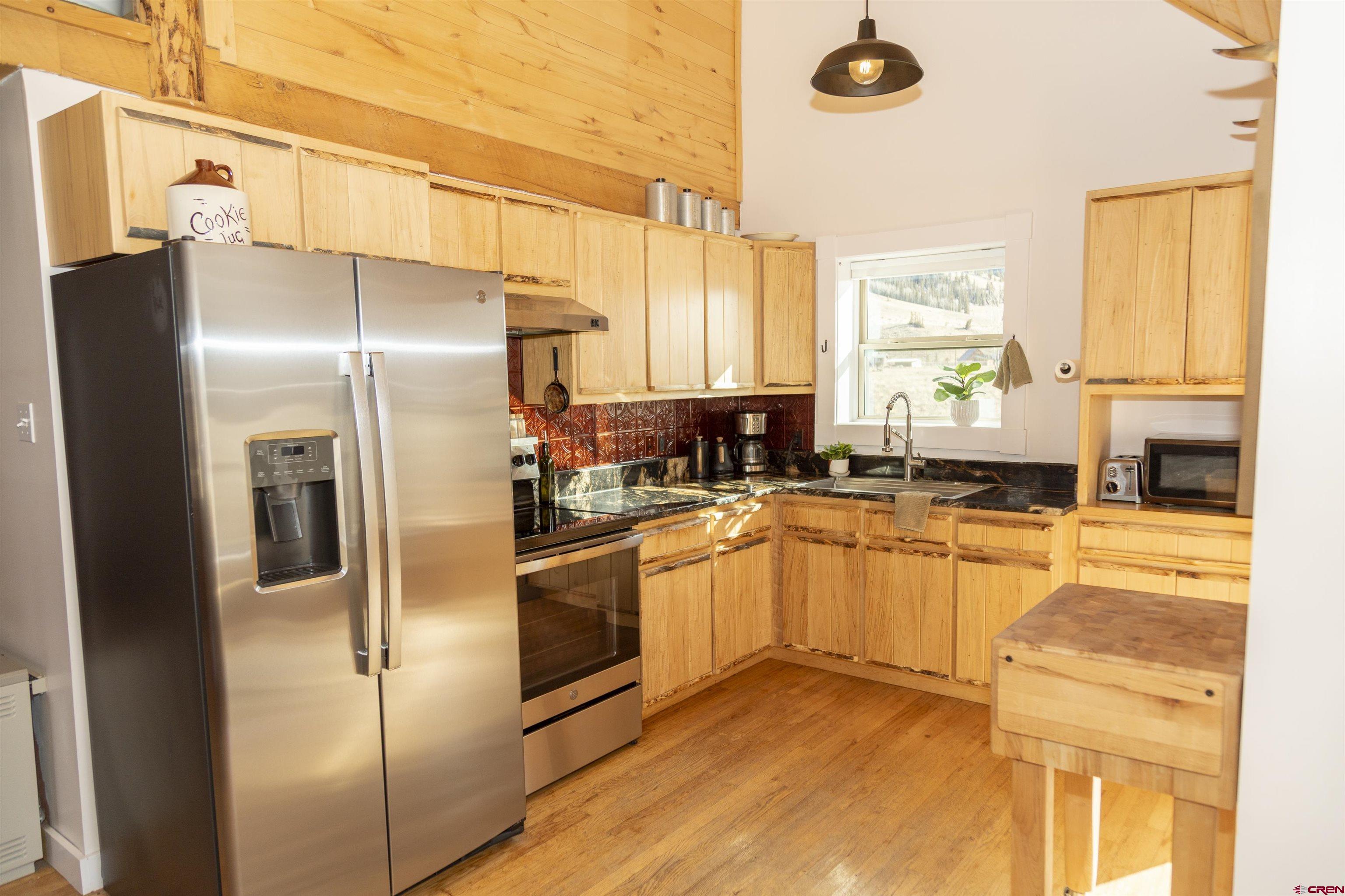 148 Rio Grande Drive Creede, CO 81130 - Photo 5 of 38 a kitchen with stainless steel appliances a refrigerator sink and cabinets