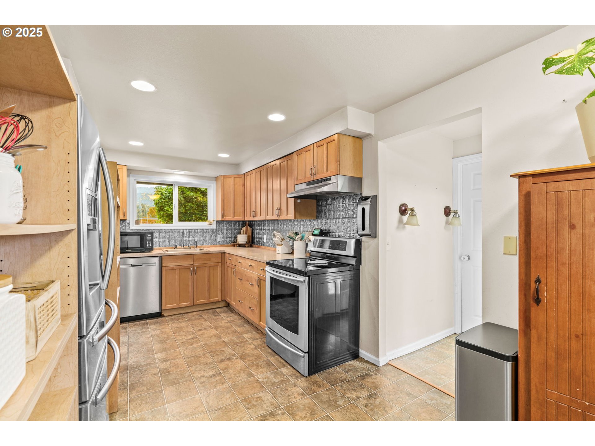 2945 Hayden Bridge Road Springfield, OR 97477 - Photo 6 of 46 a kitchen with stainless steel appliances granite countertop a refrigerator a sink a stove a microwave and island