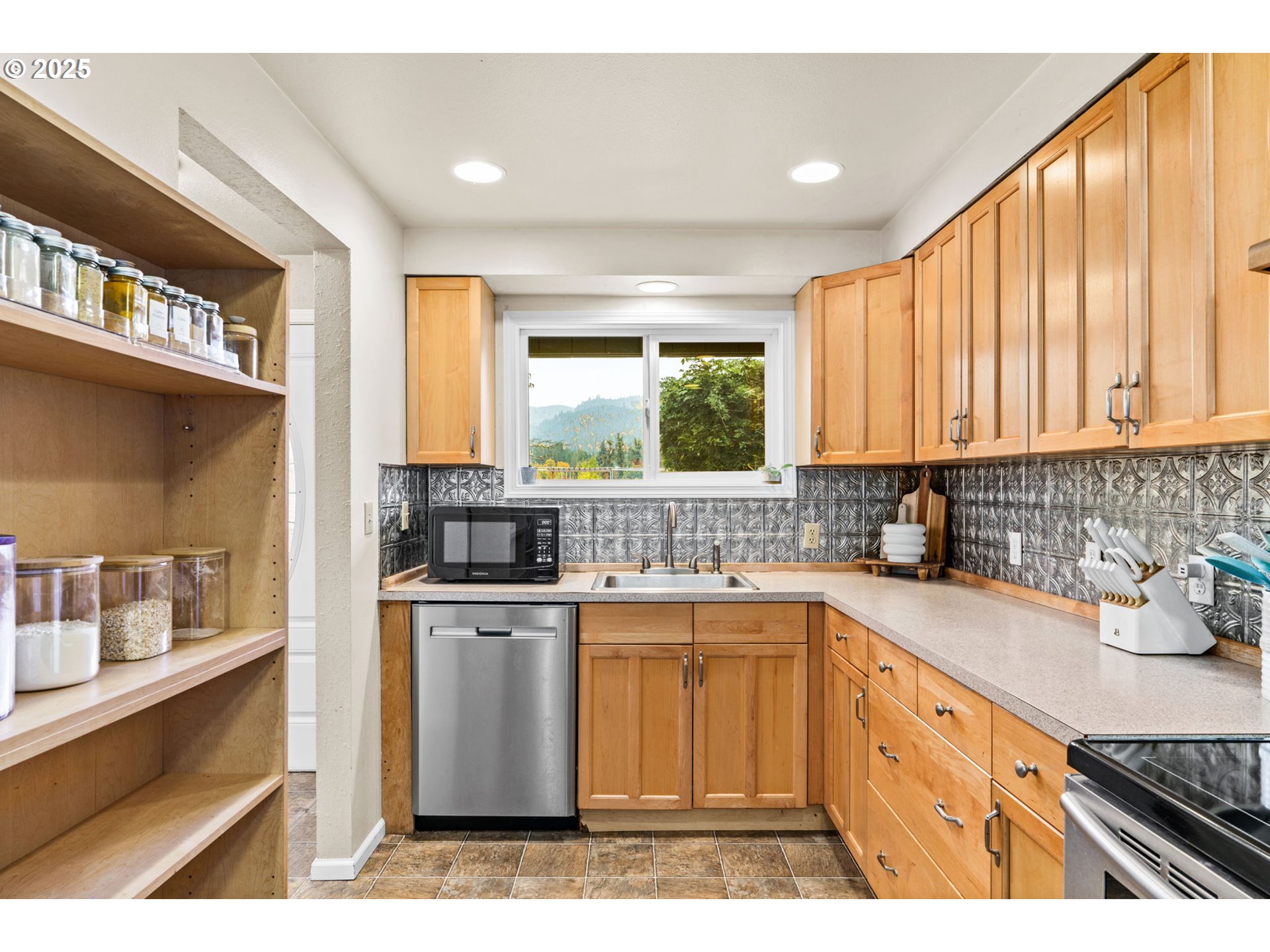 2945 Hayden Bridge Road Springfield, OR 97477 - Photo 8 of 46 a kitchen with stainless steel appliances granite countertop a stove a sink and a microwave