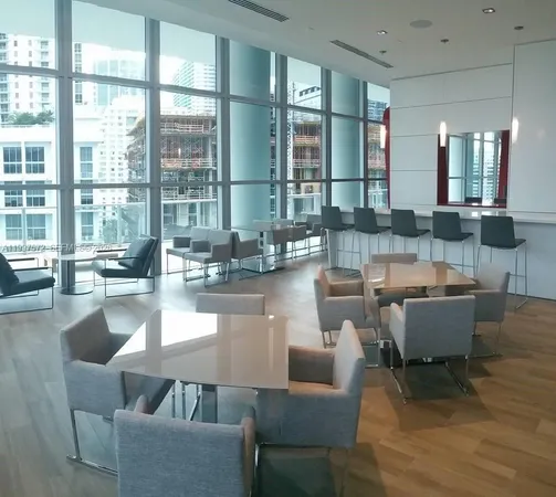 a view of a balcony with furniture and a floor to ceiling window