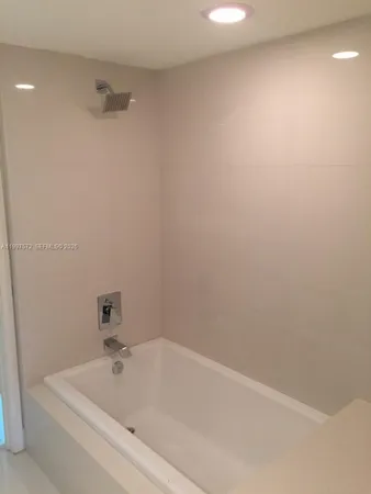 a white bath tub sitting in a bathroom