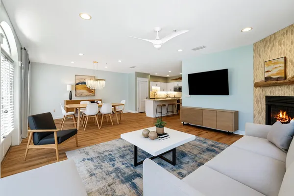 a living room with furniture a rug and a flat screen tv