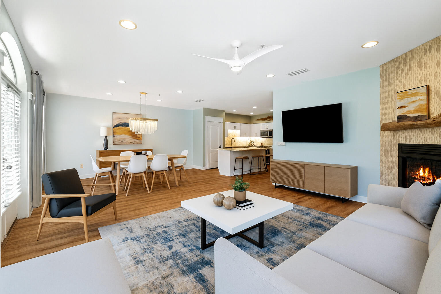 a living room with furniture a rug and a flat screen tv