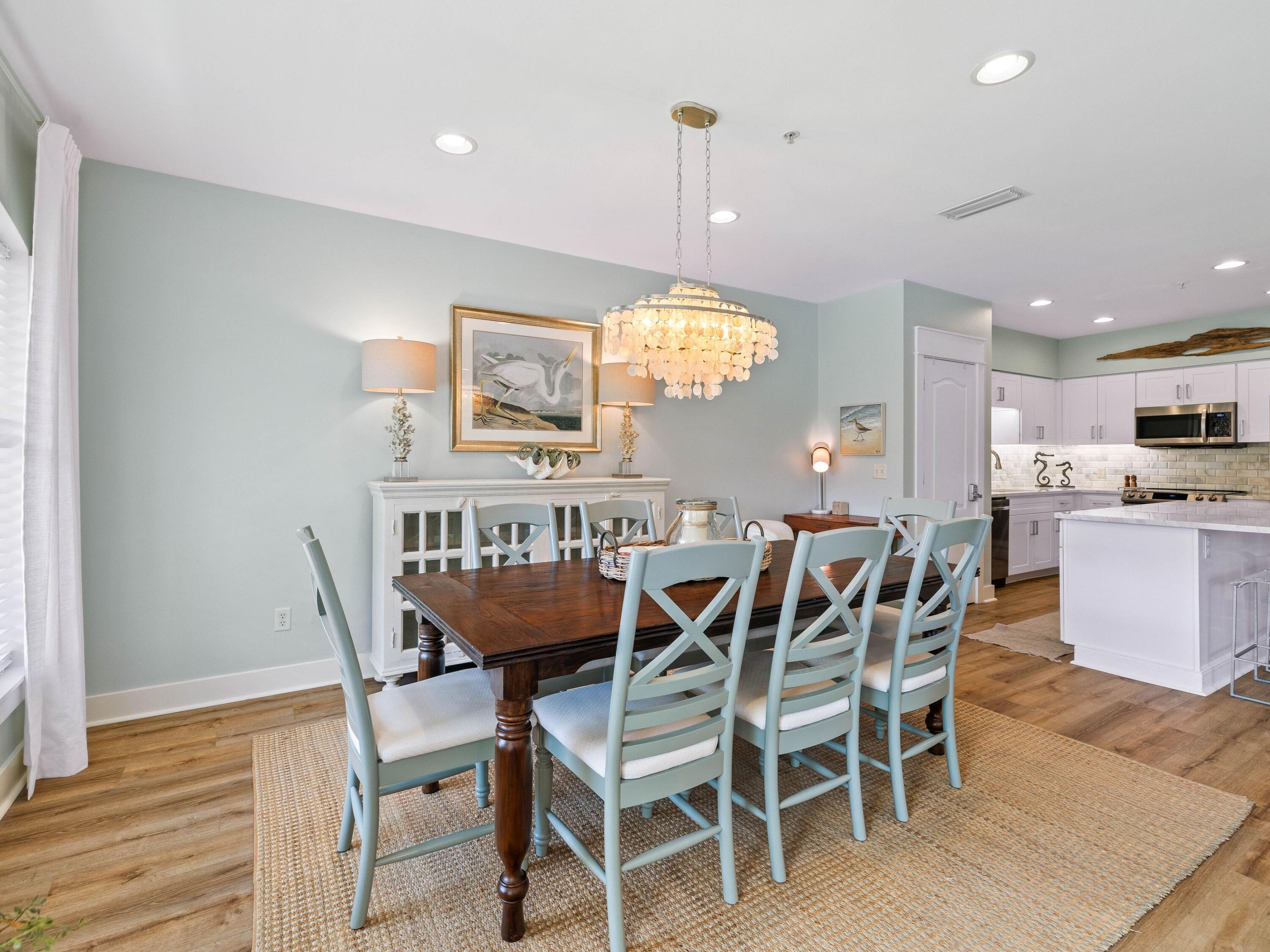 4545 East County Highway 30A, Unit C101 Santa Rosa Beach, FL 32459 - Photo 17 of 29 a view of a dining room with furniture and wooden floor