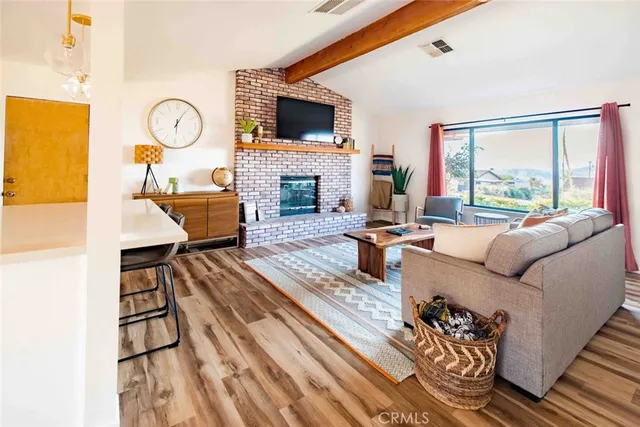 a living room with furniture fireplace and a flat screen tv
