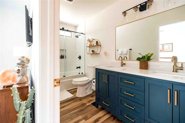 a bathroom with a sink a toilet and shower