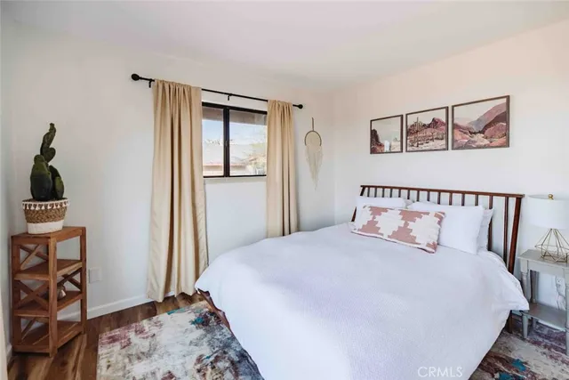 a bedroom with a large bed and a window