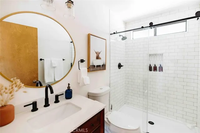 a bathroom with a sink a toilet and shower