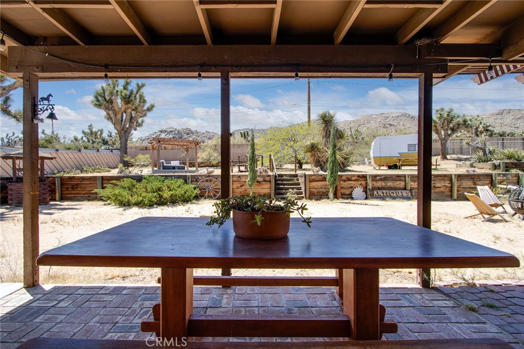 61029 Navajo Trail Joshua Tree, CA 92252 - Photo 28 of 41 a view of a dining table and chairs in the patio