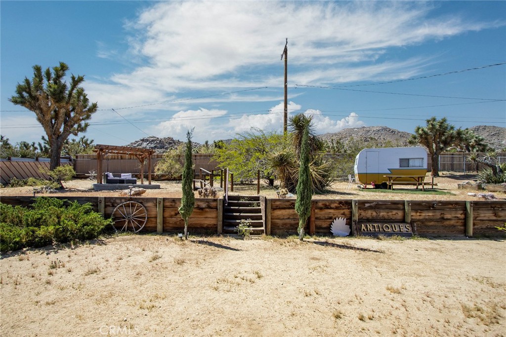 61029 Navajo Trail Joshua Tree, CA 92252 - Photo 31 of 41 a view of a terrace with a tree