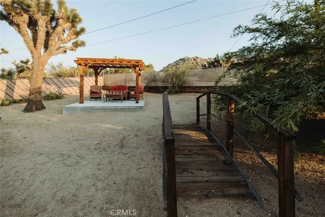 a view of a pathway with a wrought fence