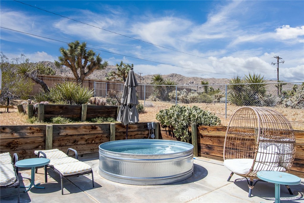 61029 Navajo Trail Joshua Tree, CA 92252 - Photo 38 of 41 a building outdoor space with patio couches and potted plants