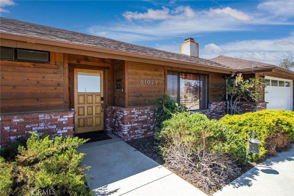 61029 Navajo Trail Joshua Tree, CA 92252 - Photo 6 of 41 a front view of a house with garden