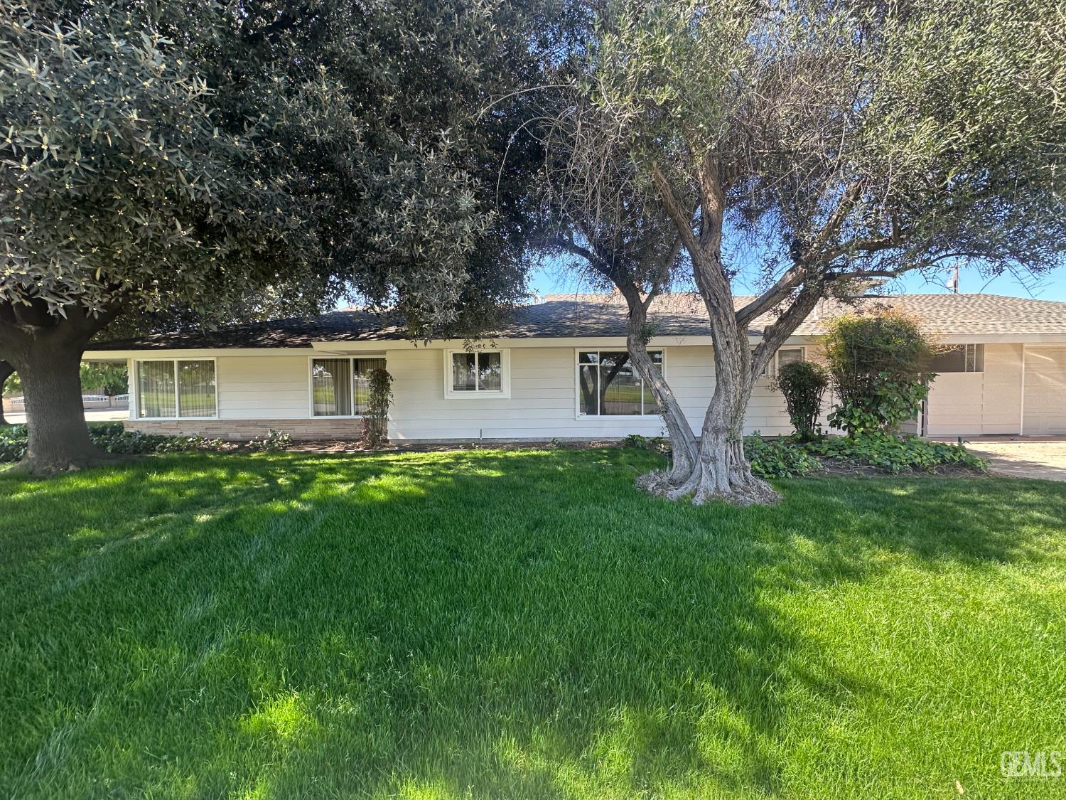 Undisclosed Address Wasco, CA 93280 - Photo 2 of 11 a front view of house with yard and green space