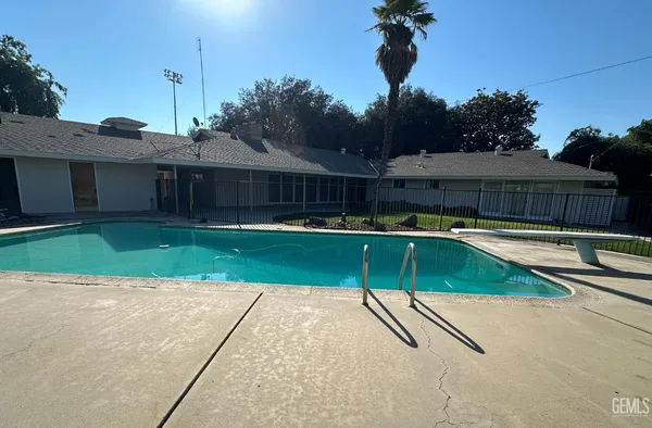 a view of a backyard with a swimming pool