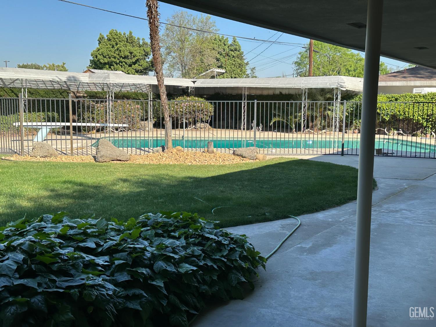 Undisclosed Address Wasco, CA 93280 - Photo 5 of 11 a view of a house with backyard and porch