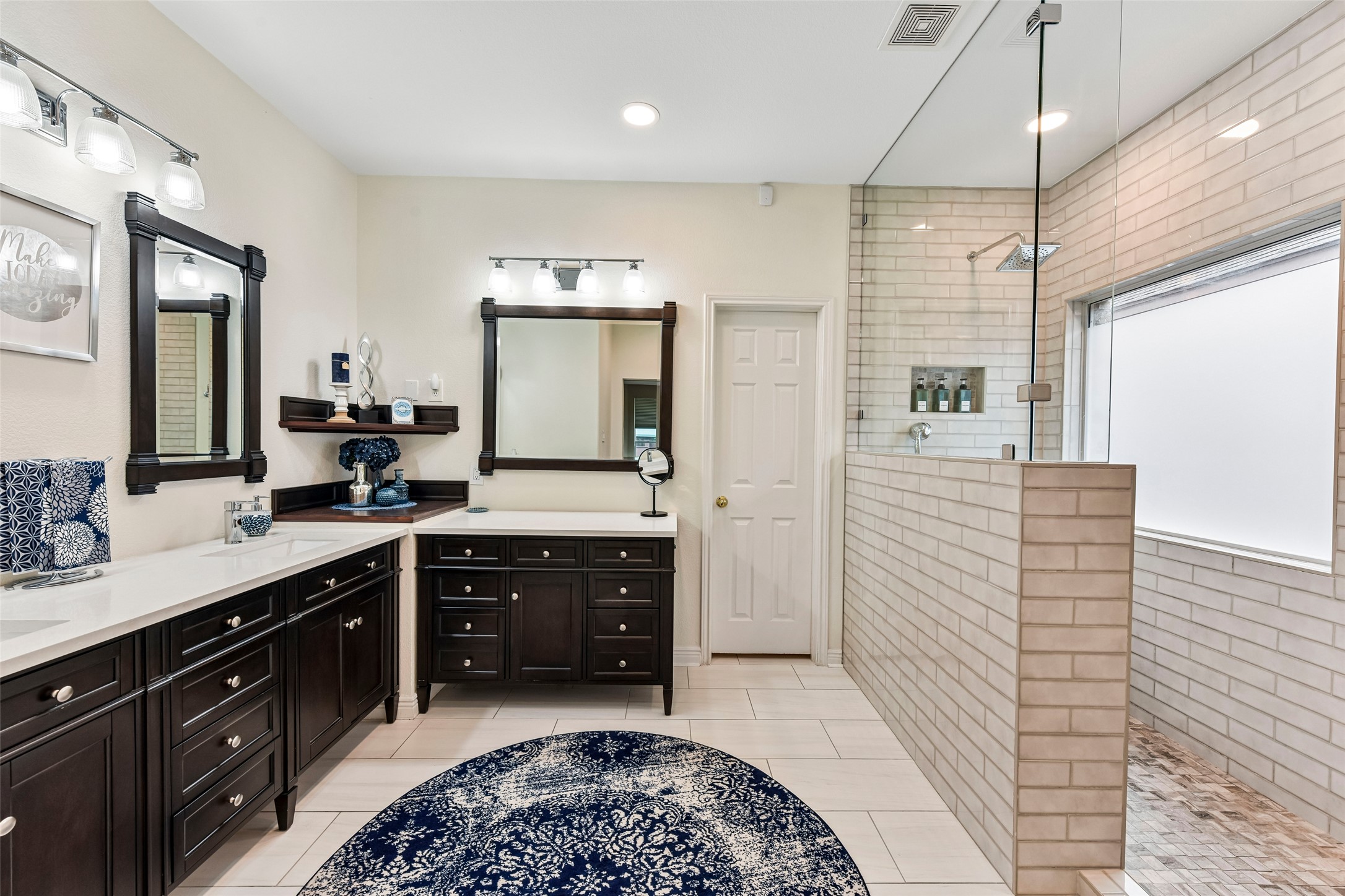 a spacious bathroom with a sink a vanity a mirror and shower