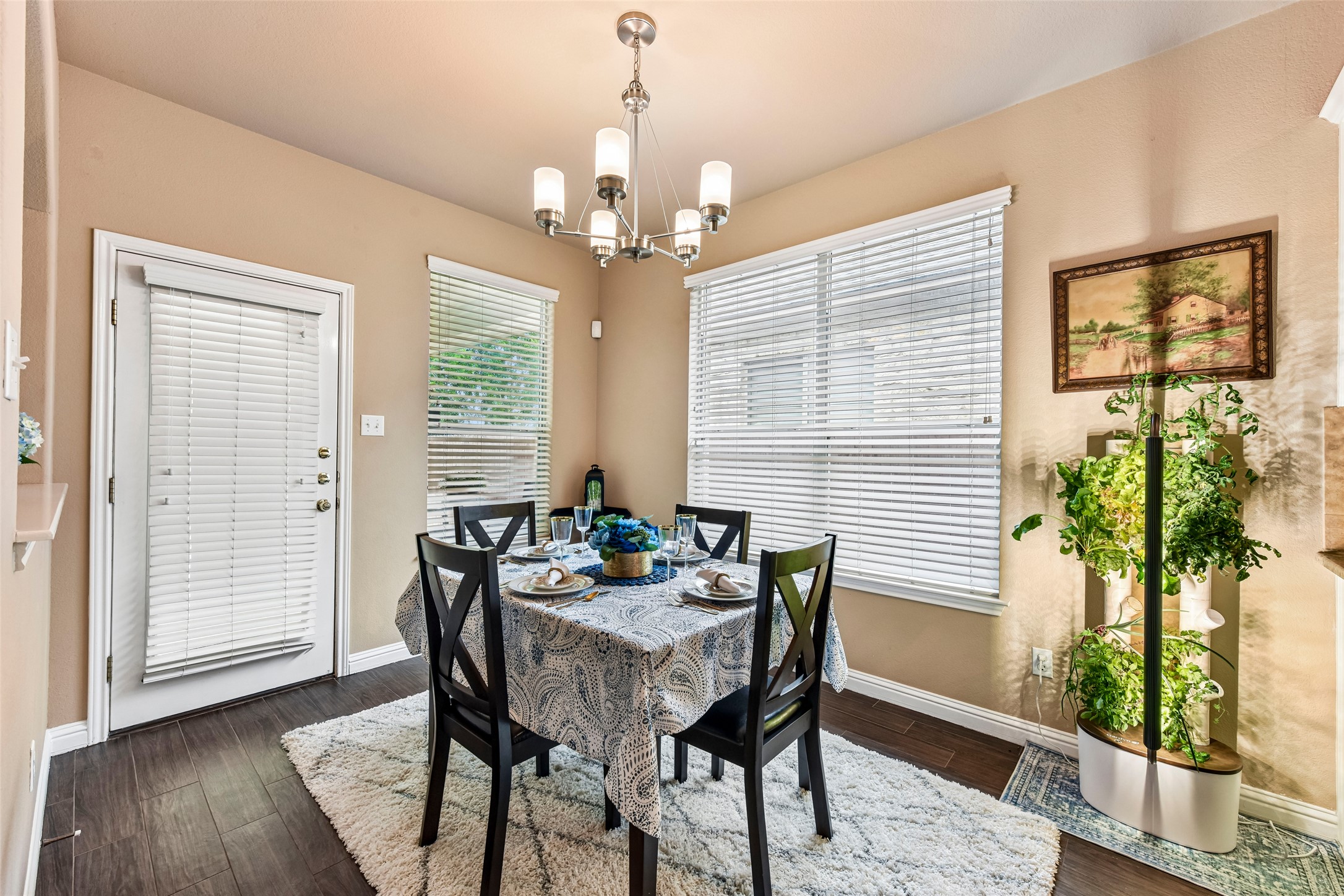 10216 Anahuac Trail Austin, TX 78747 - Photo 13 of 39 a dining room with furniture potted plants and wooden floor