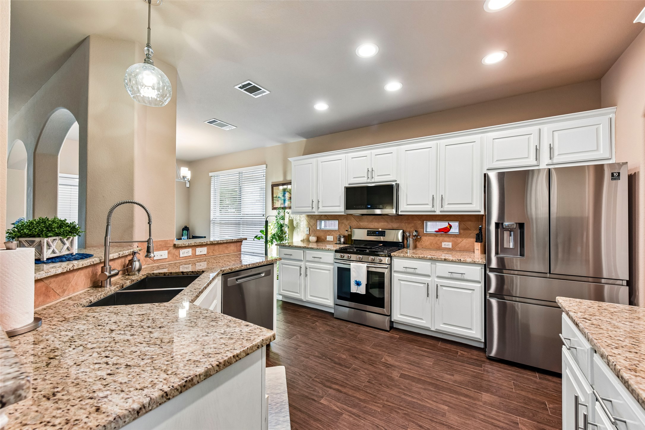 10216 Anahuac Trail Austin, TX 78747 - Photo 15 of 39 a kitchen with kitchen island granite countertop stainless steel appliances and sink